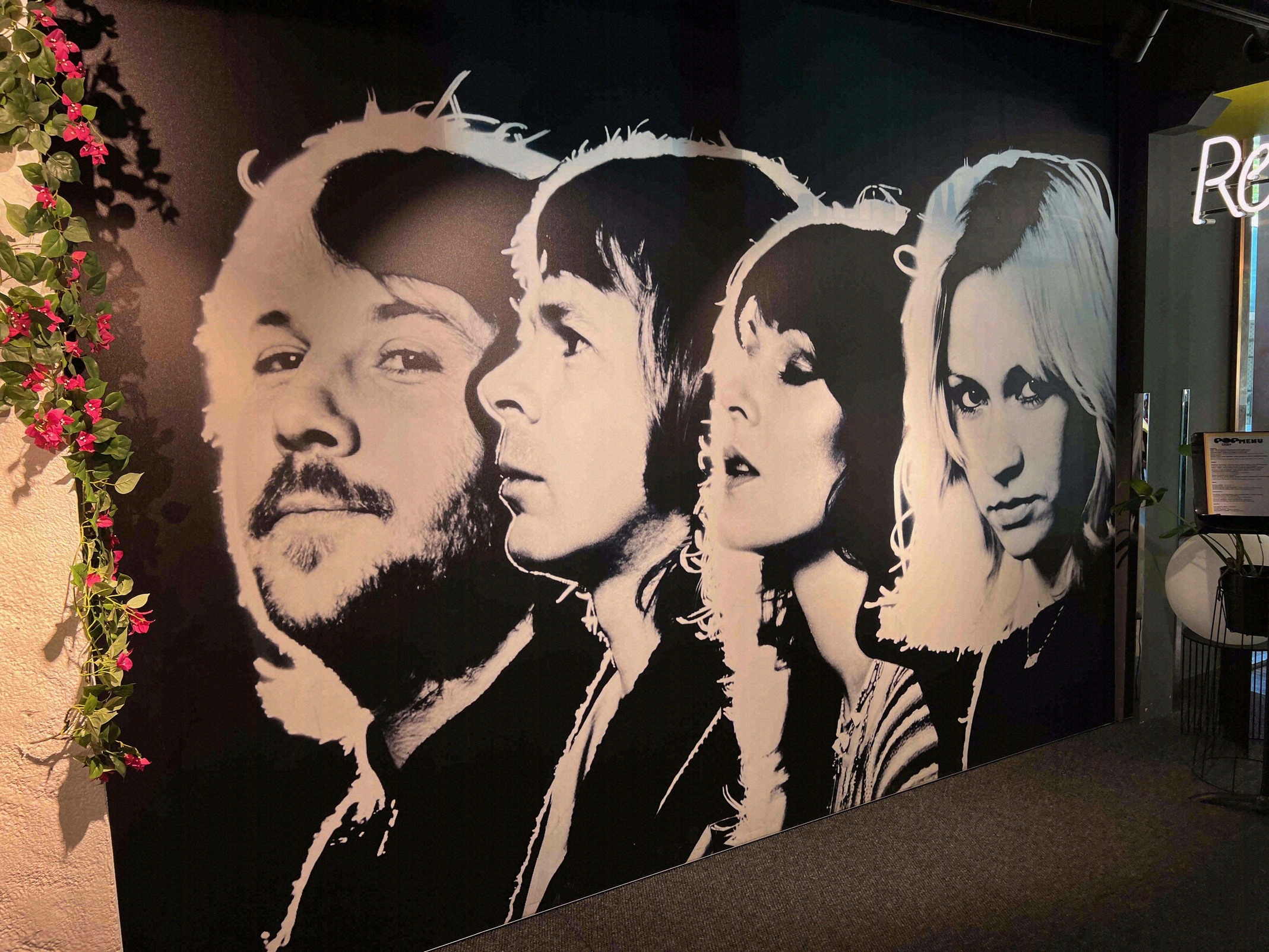 Large black-and-white mural of the four ABBA members inside the museum