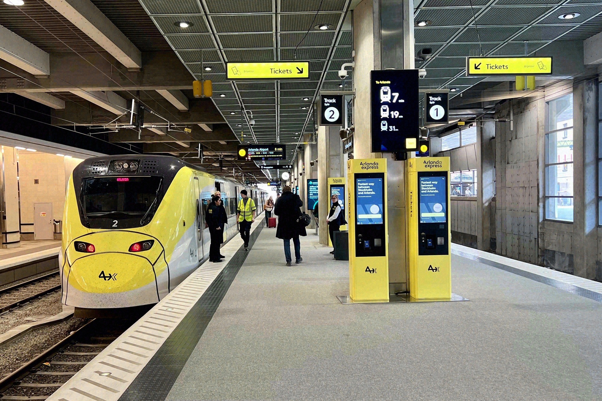 The Arlanda Express at the platform of Stockholm Central Station. The yellow Arlanda Express train at the platform