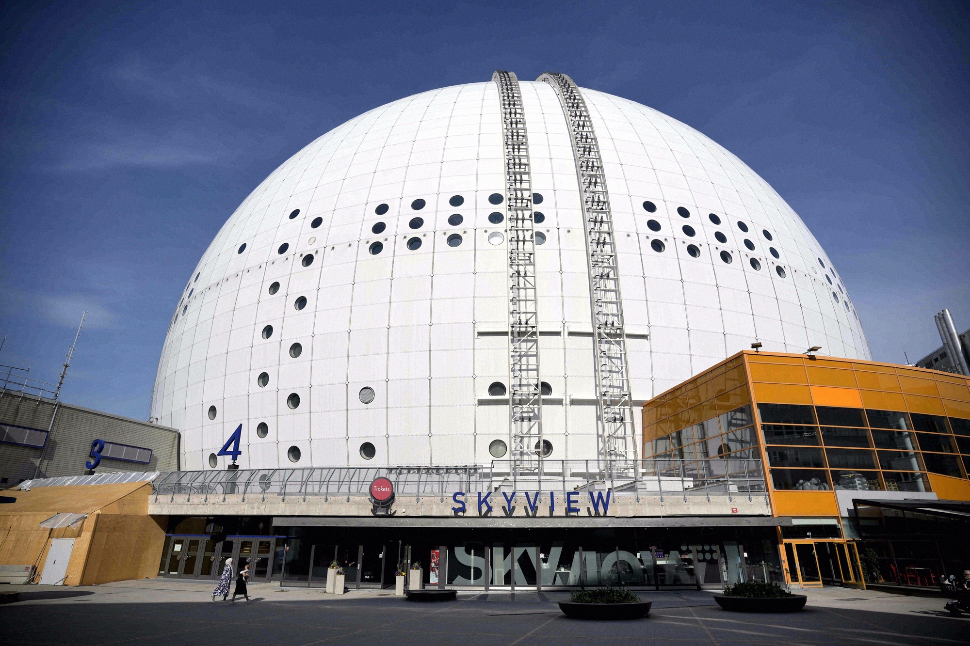 The white dome of the Avicii Arena with the SkyView gondola track on the outer shell. The white dome of the Avicii Arena with the SkyView gondola track on the outer shell