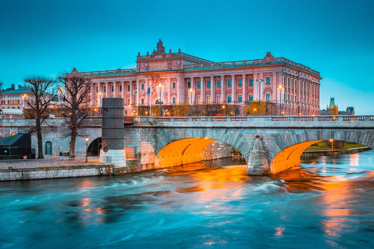 The Norrbro at twilight — beneath its arches, the lit windows of the Medeltidsmuseet