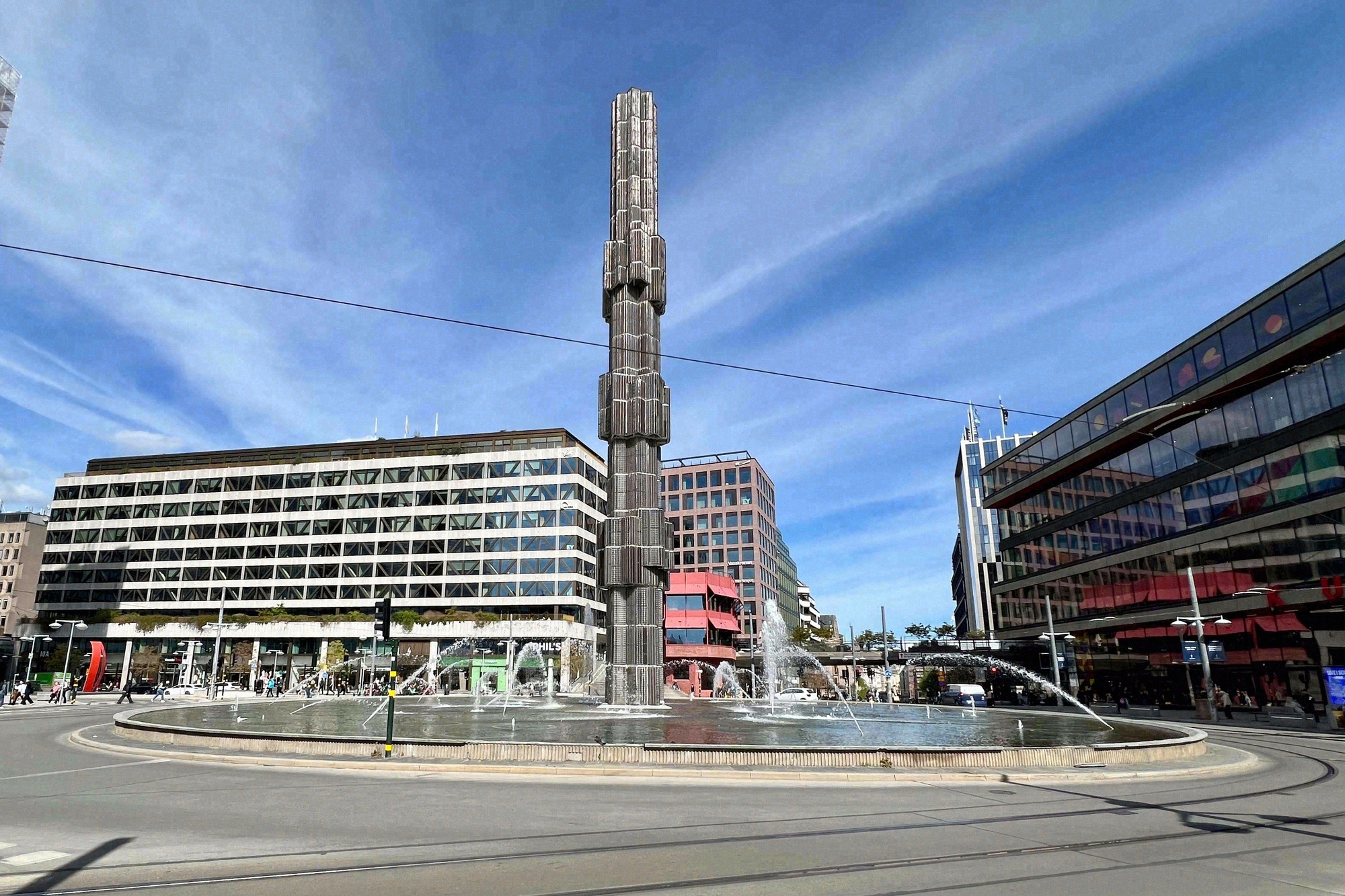 Sergels torg with the tall glass obelisk and fountain amid the city buildings