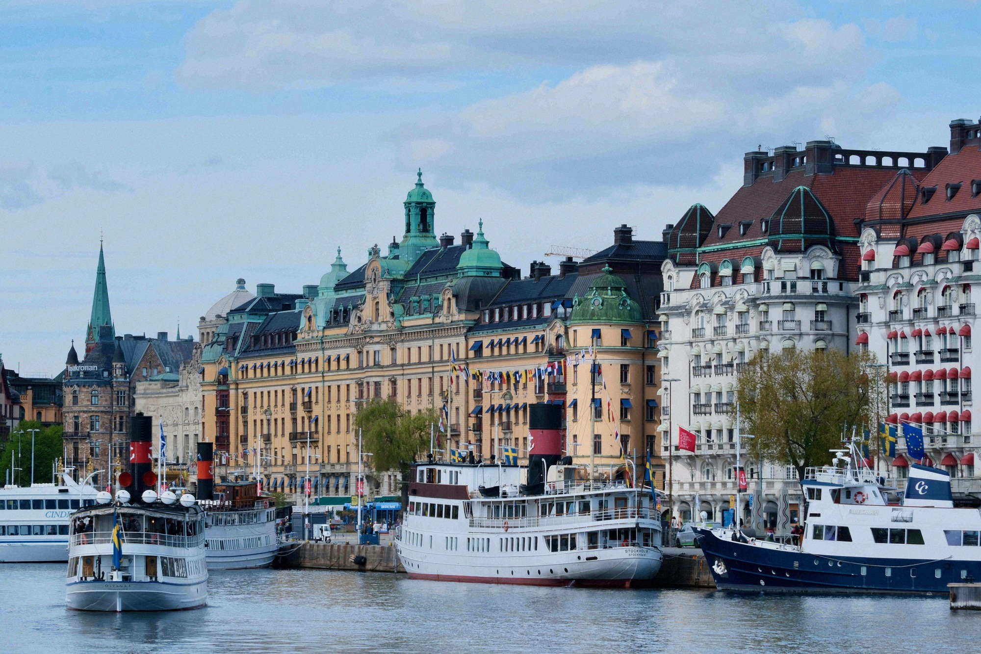 The Strandvägen promenade with moored steamboats. The Strandvägen waterfront promenade with moored steamboats and grand buildings